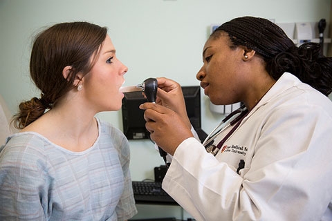 Doctor inspecting patient's mouth