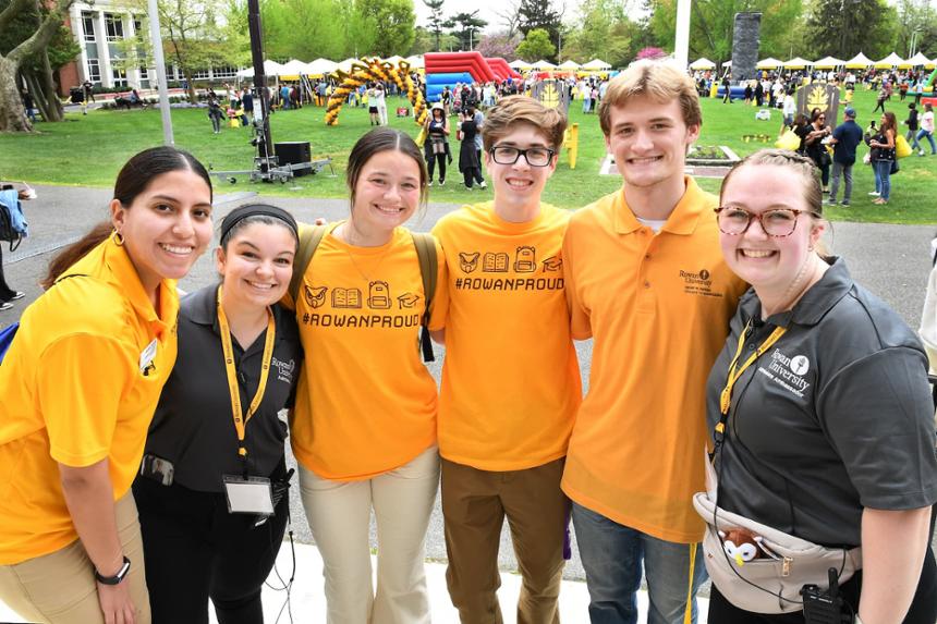 six Rowan helpers and students smiling in front of the Robinson Green