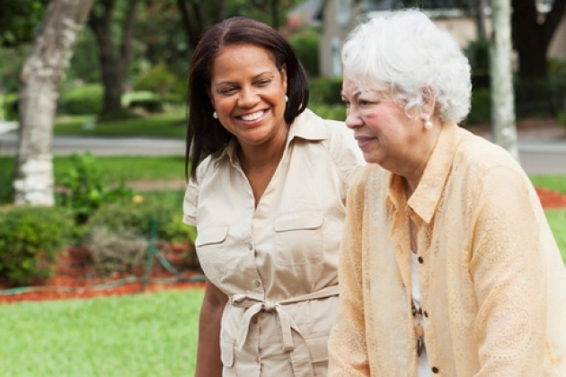 A younger and elderly woman walking together