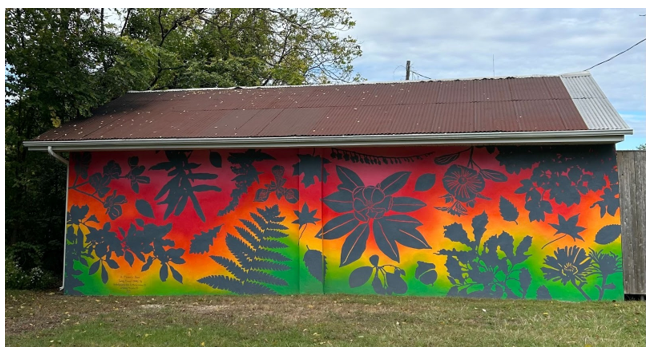 A Moment's Pause Mural, located on Meditation Walk, displaying vibrant colors including red, green,yellow and hints of orange and foliage