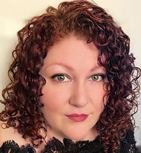 close up head shot of woman with curly hair 