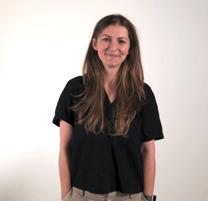 Erin Clare wearing a black shirt smiling at the camera.