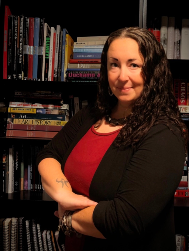 Jessica Drass wearing a black t-shirt, smiling at the camera.