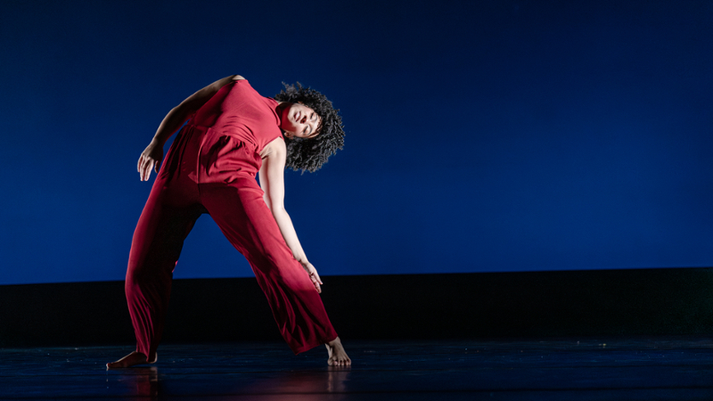 Click to learn more about the Department of Theatre & Dance, dance student arched backward on a stage