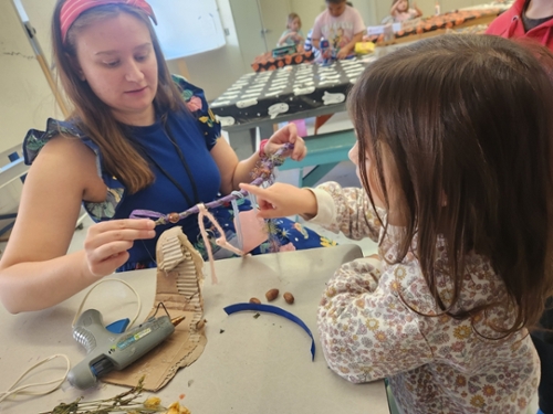 children in an art classroom with a teacher