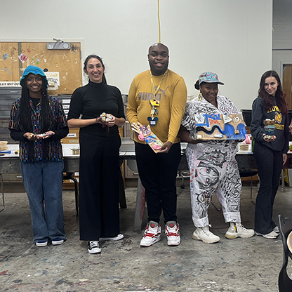 vanessa german stands with a group of students.