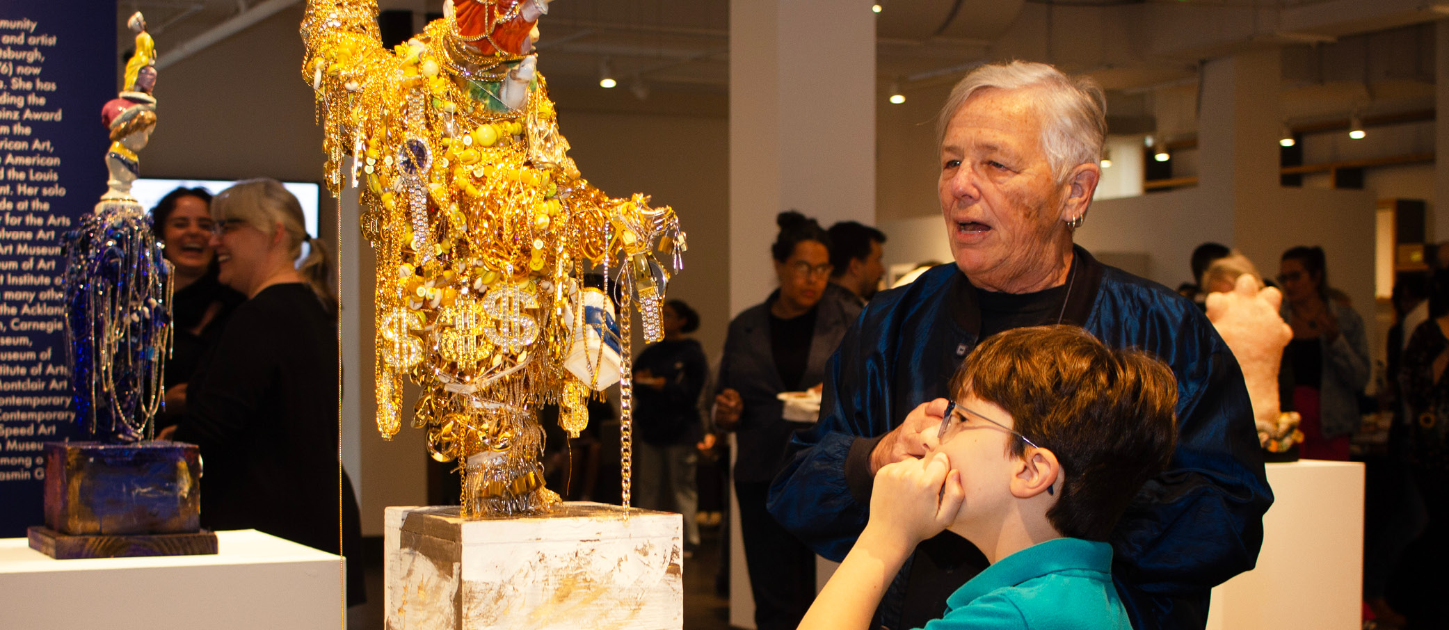 Visitors looking at artwork on display.