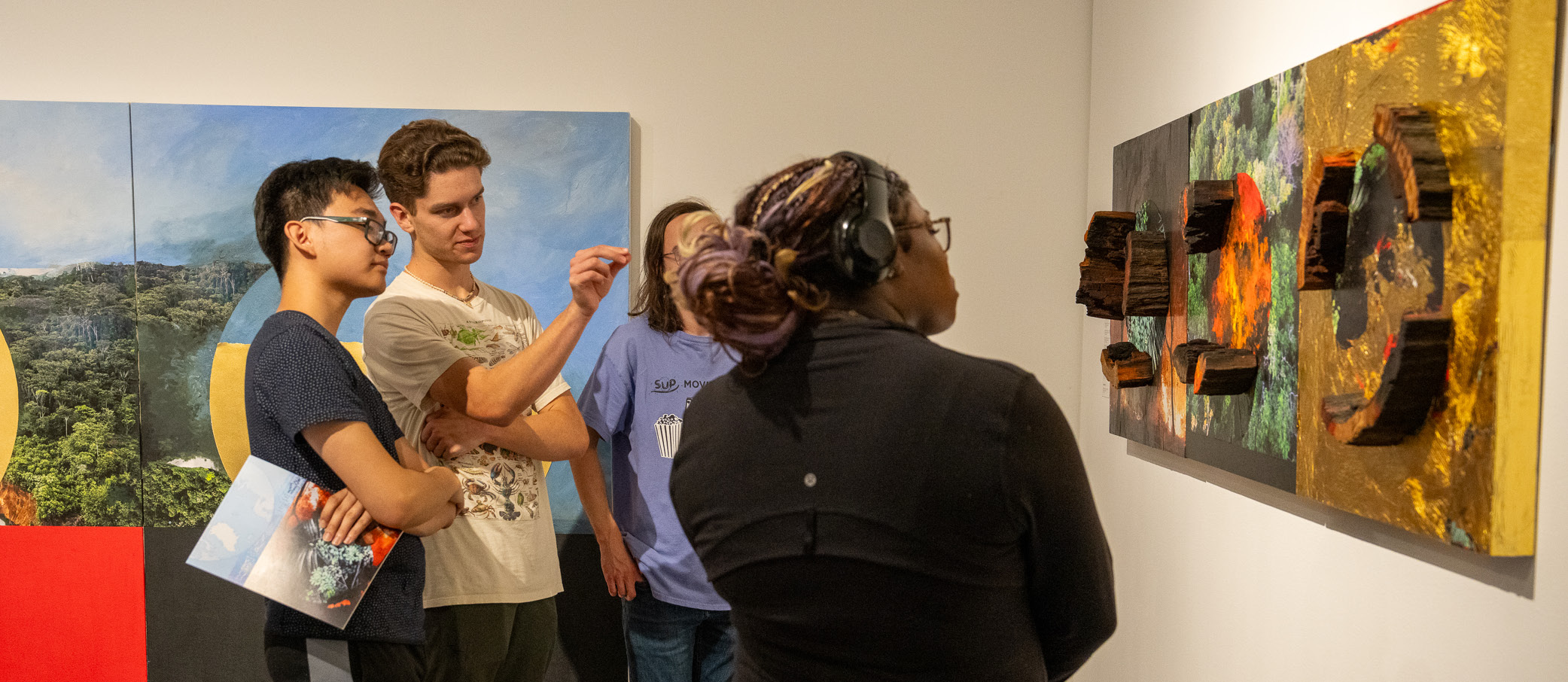 Visitors in the Diane Burko Extraction A Dialogue of Extremes exhibition.