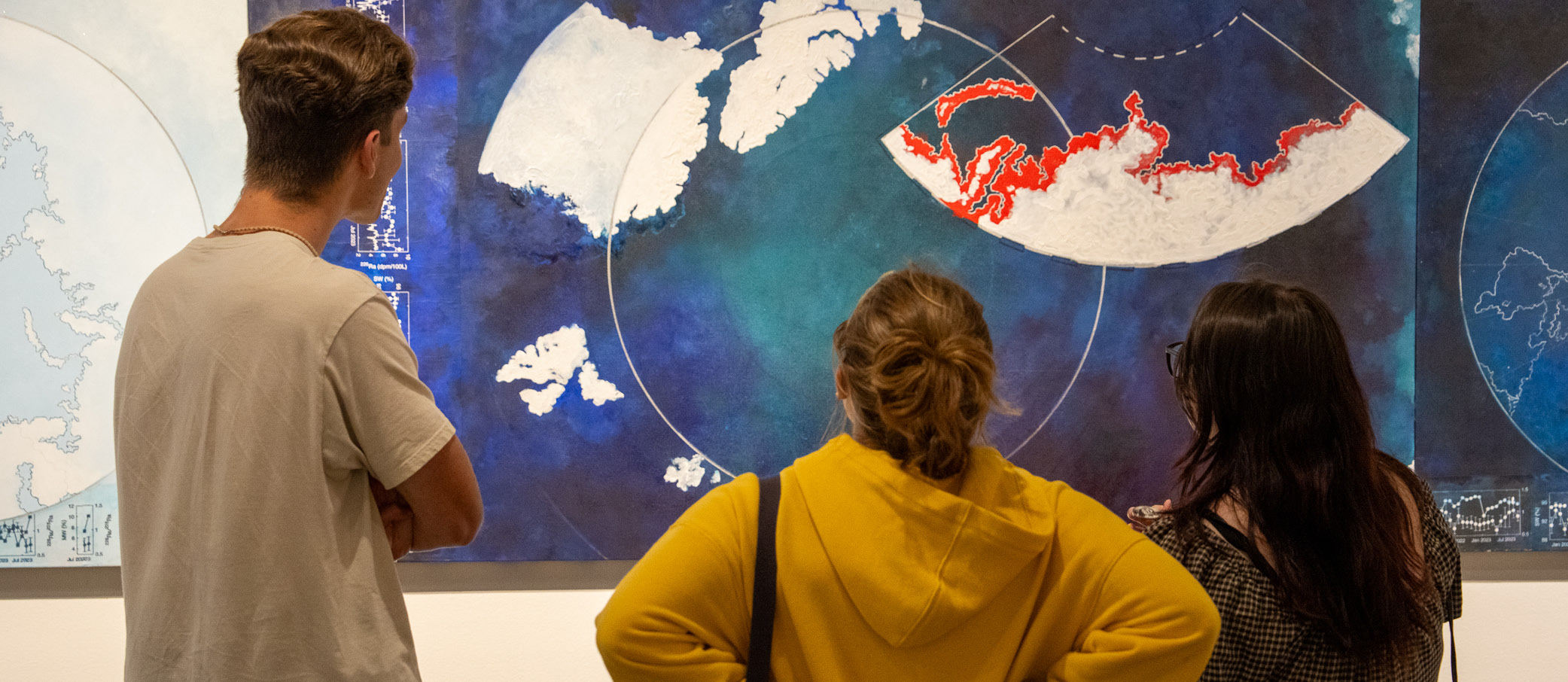 Visitors in the Diane Burko Extraction A Dialogue of Extremes exhibition.