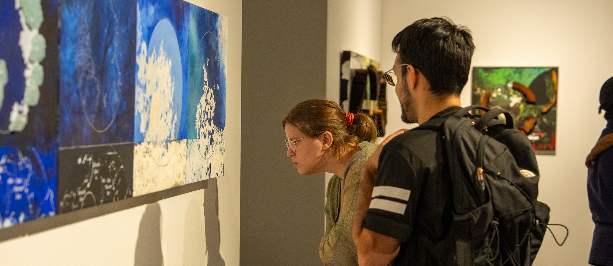 Visitors in the Diane Burko Extraction A Dialogue of Extremes exhibition.