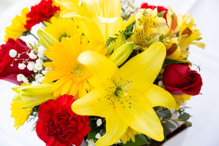A photo of a floral arrangement featuring red and yellow flowers at a recent CMSRU event.