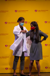 A CMSRU student receives their white coat.