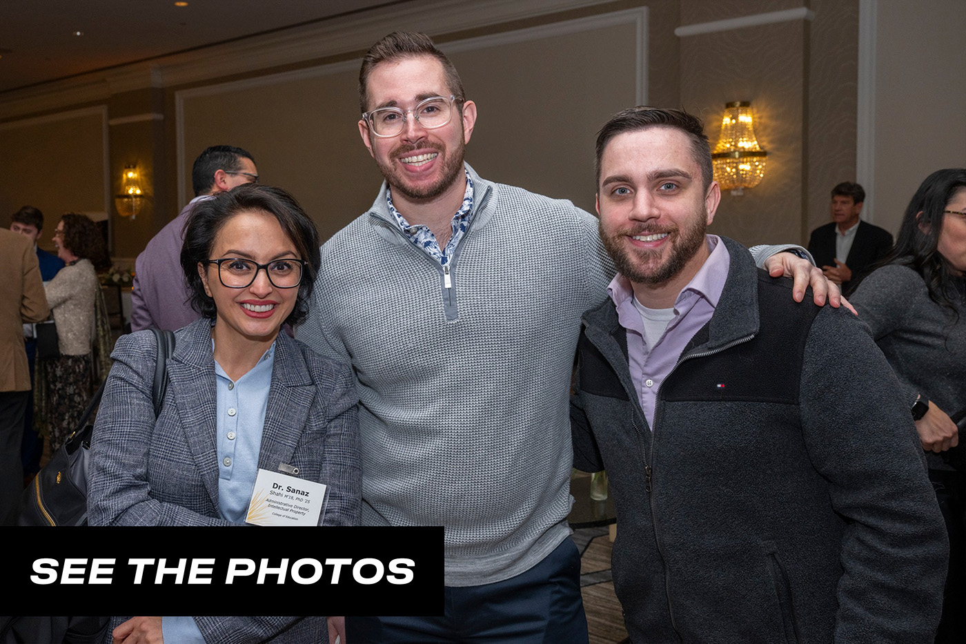 Three alumni pose for a group photo with a button that says "See the photos."