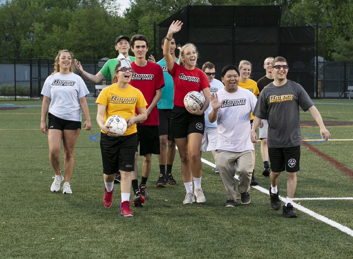 A group of students from unified sports wave.