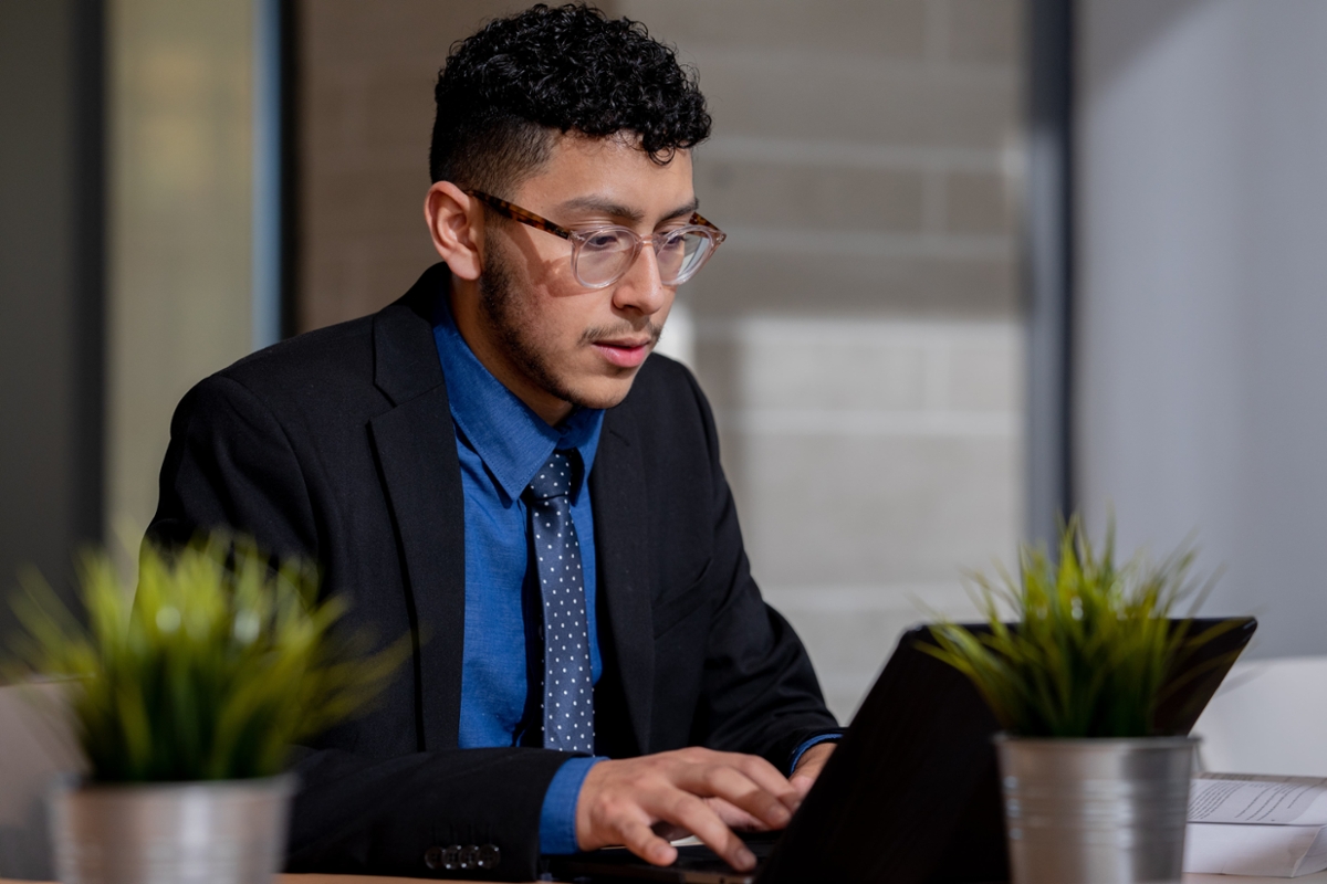 A student works on their laptop.
