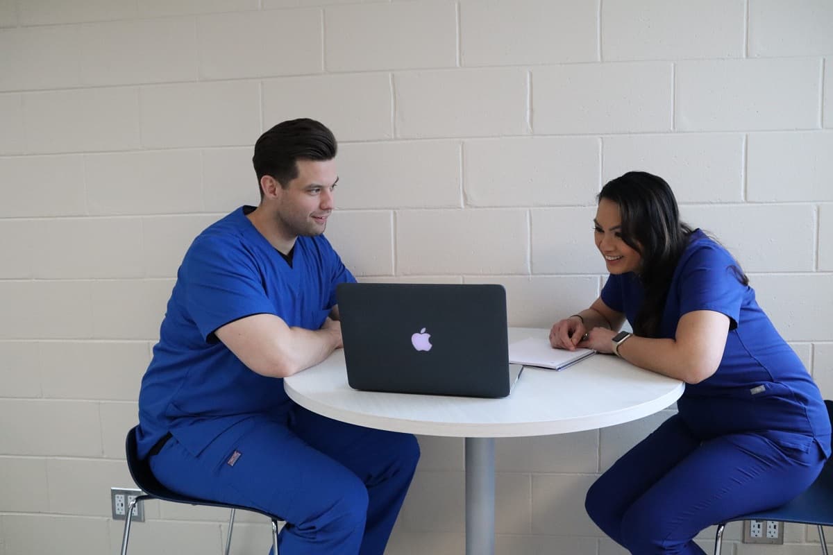Two bsrt students working together at a computer