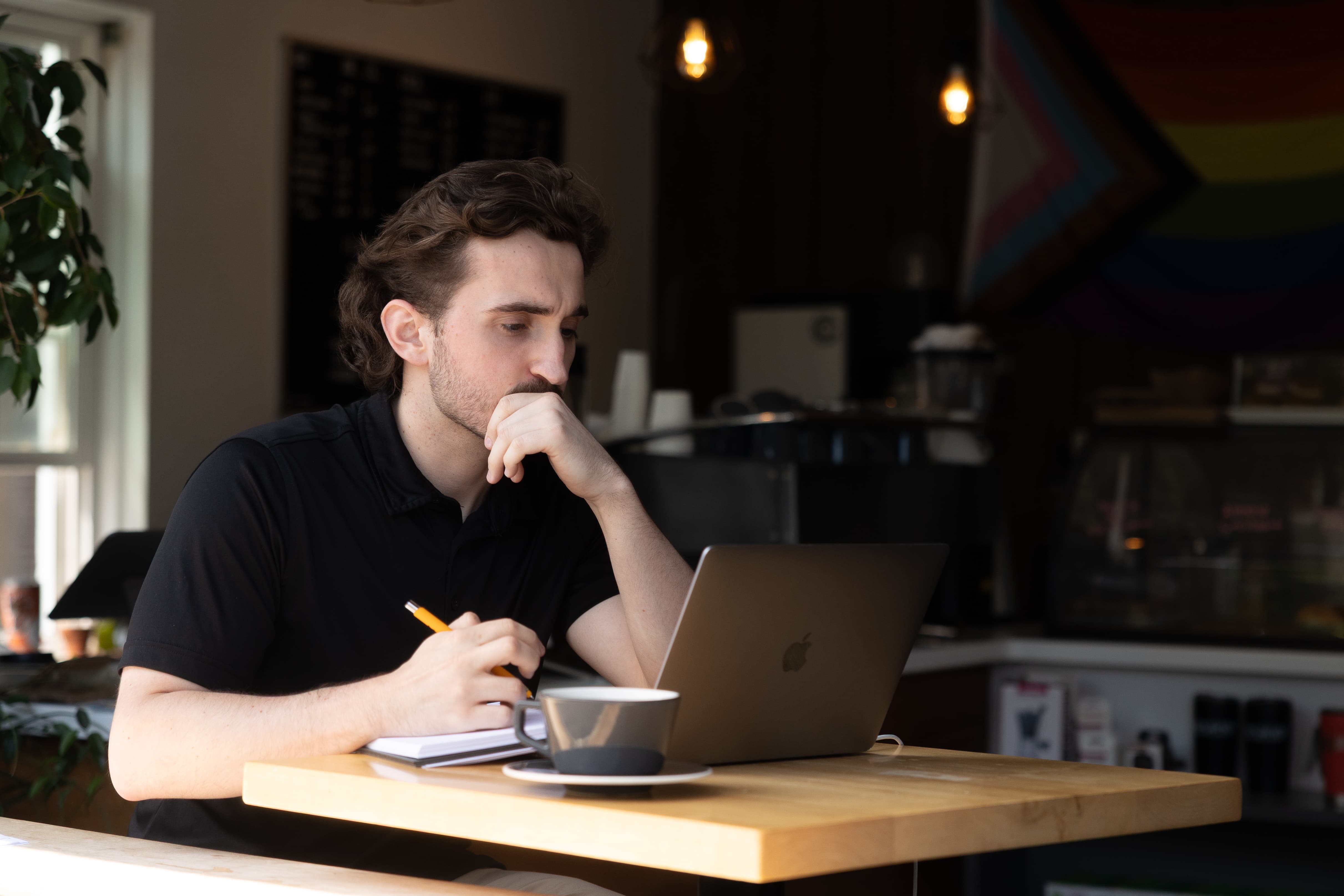 A student works on their laptop at a desk.
