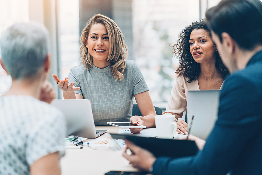 A group of professionals sitting and talking.