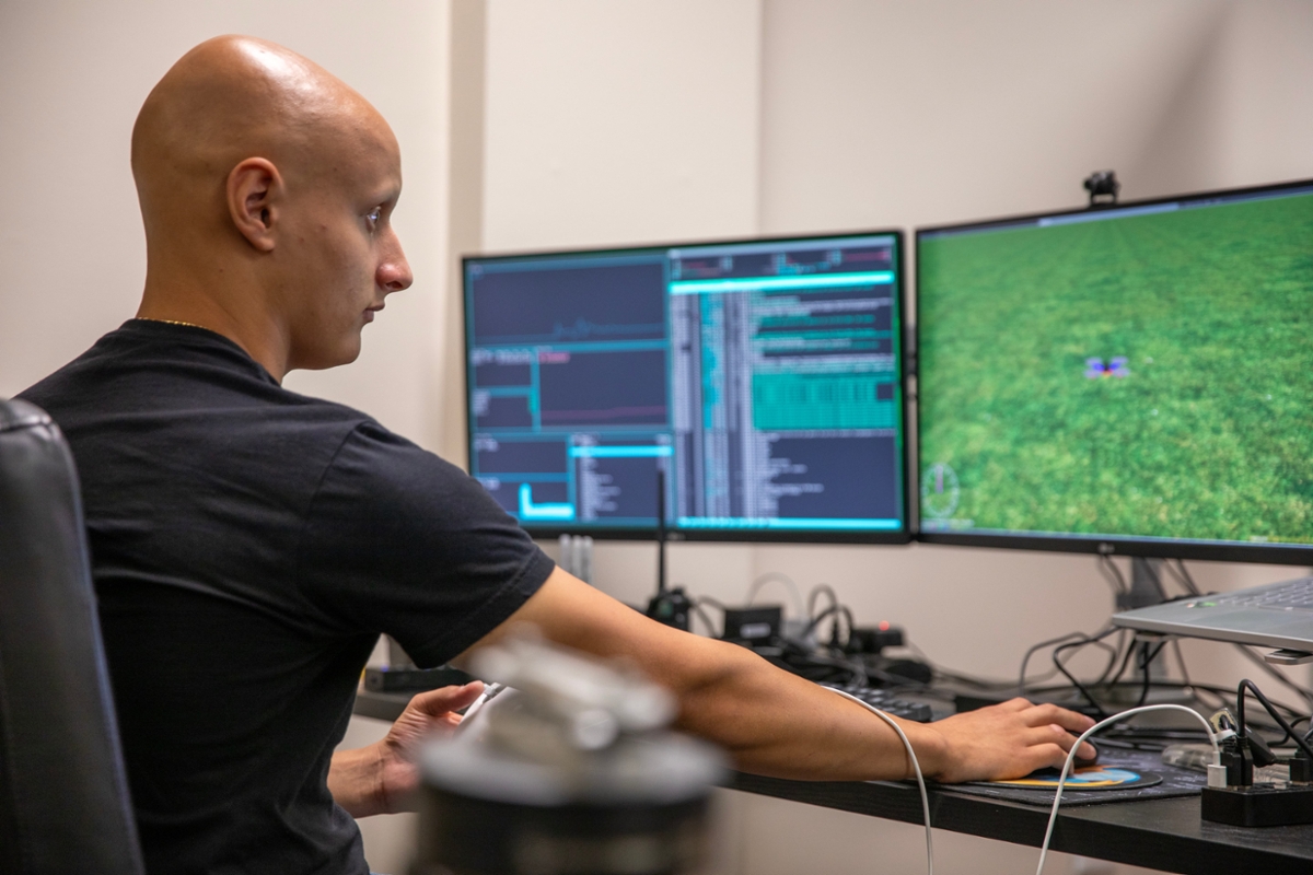 A student works on their desktop computer.