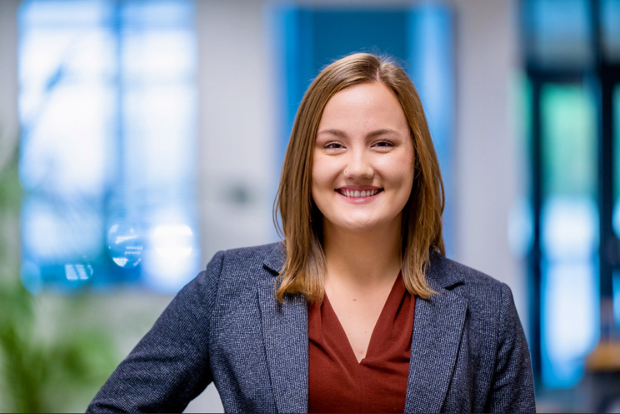 A student looks at the camera and smiles.