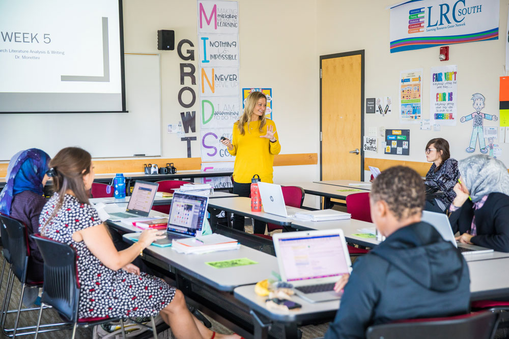 A teacher talks to students in a classroom.