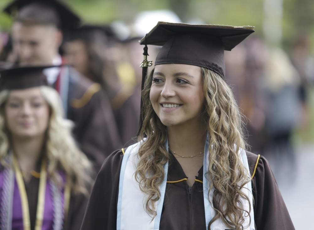 A student smiles in her graduation attire as she prepares for a Commencement ceremony on Rowan University's main campus in Glassboro, New Jersey.