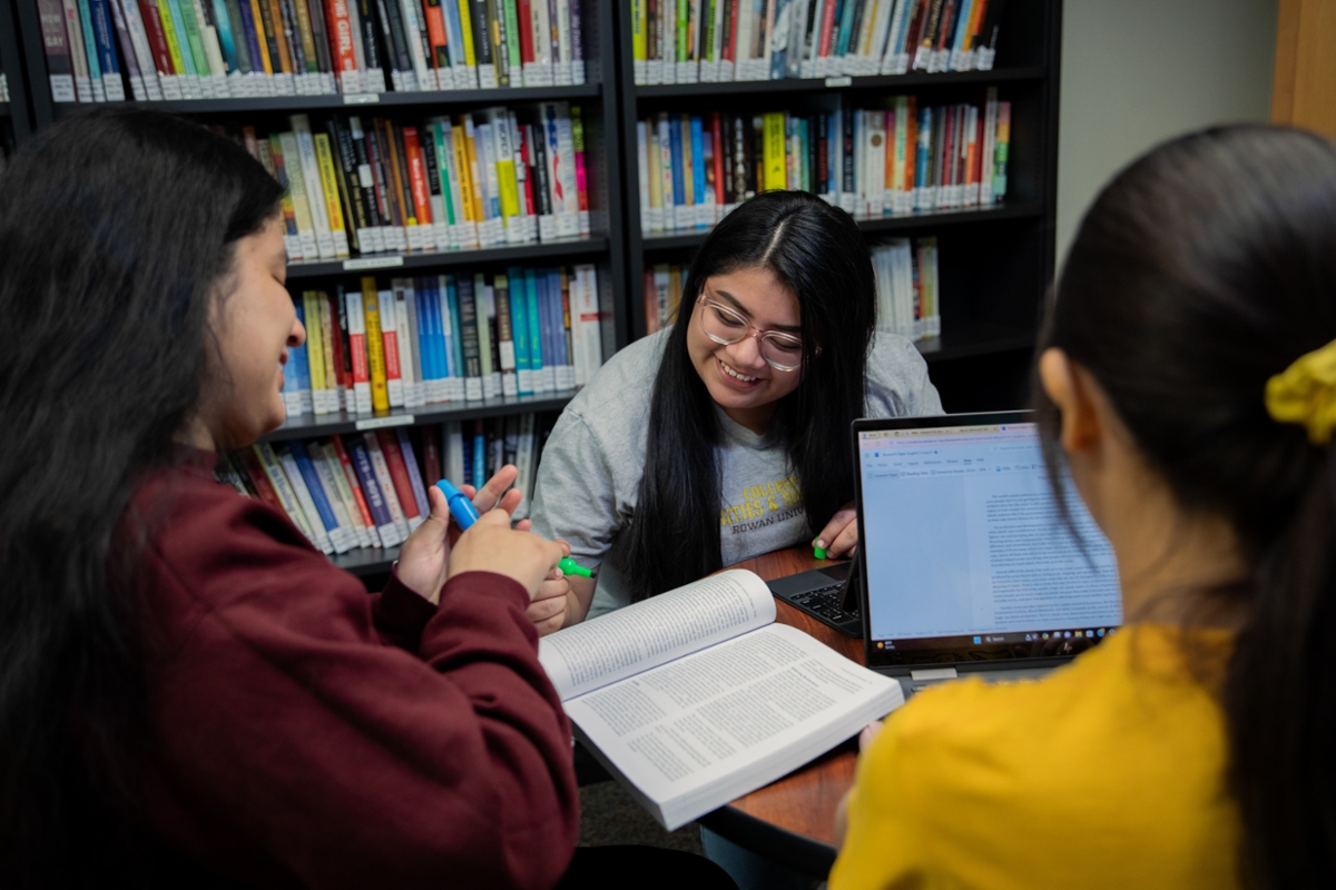 Three students work on their school work at a table in the library on Rowan's campus in Glassboro, NJ.