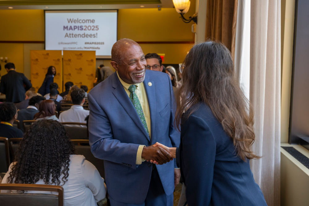 Rep. Herb Conaway shaking hands with an intern at MAPIS2025