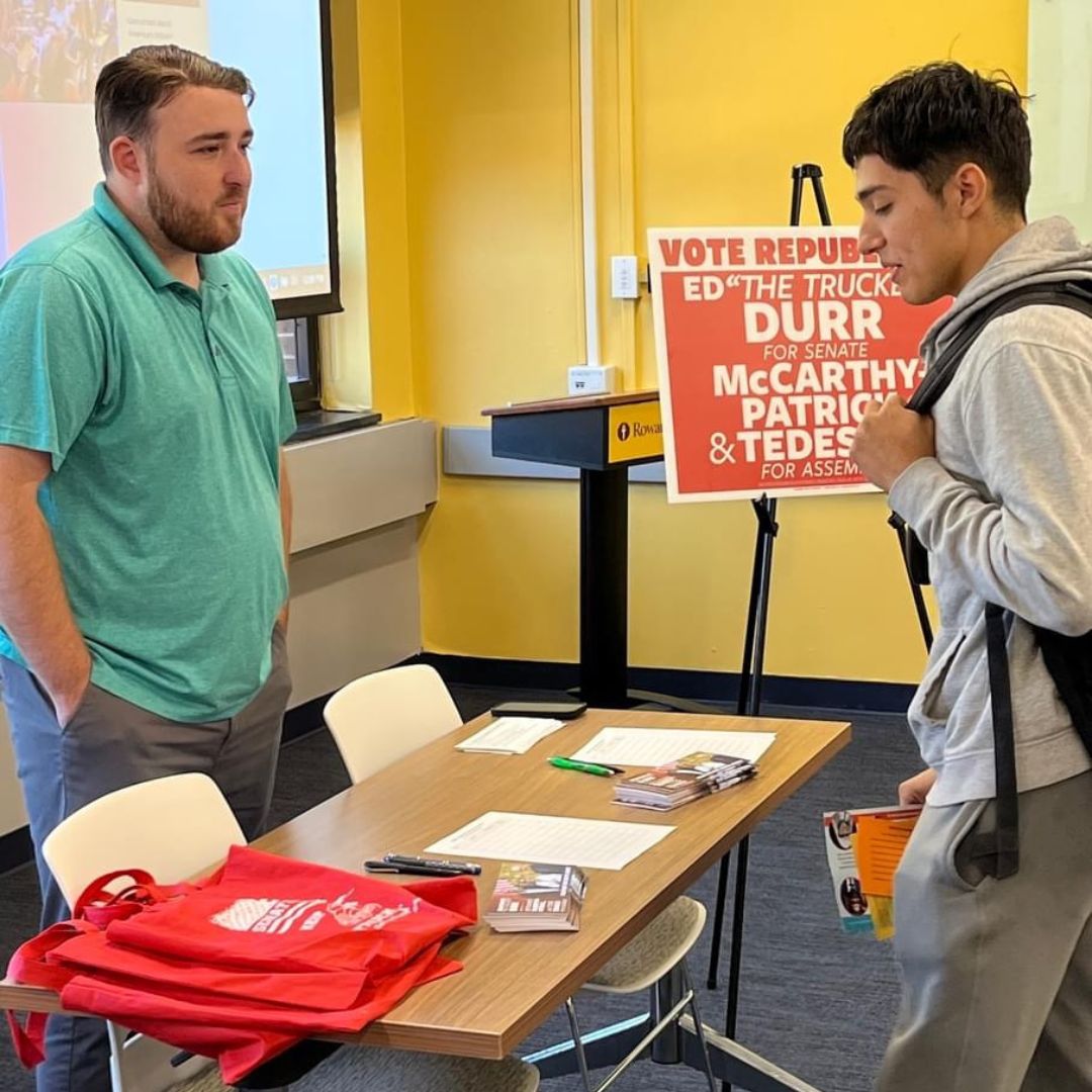 Students speaking with Durr campaign table at 2023 RIPPAC Political Campaign Volunteer Fair