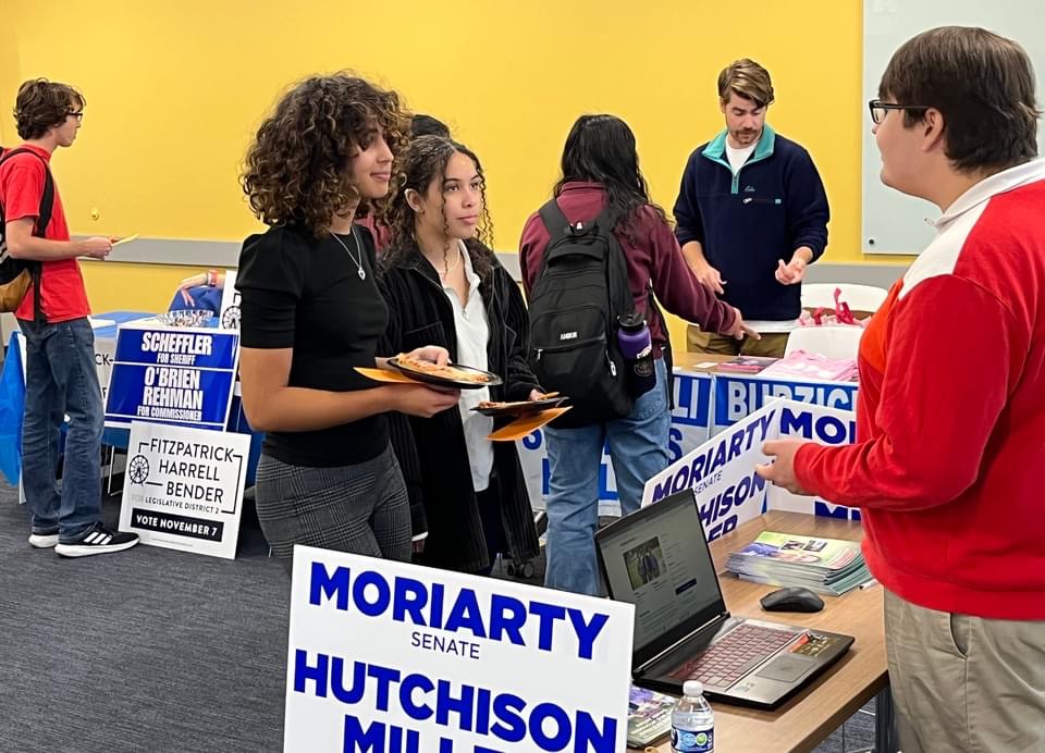 Students talking to Democratic campaign tables at the 2023 RIPPAC Political Campaign Volunteer Fair