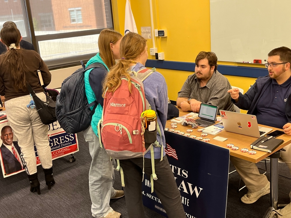 Students talk to representatives of the Curtis Bashaw campaign at the 2024 RIPPAC Political Campaign Volunteer Fair