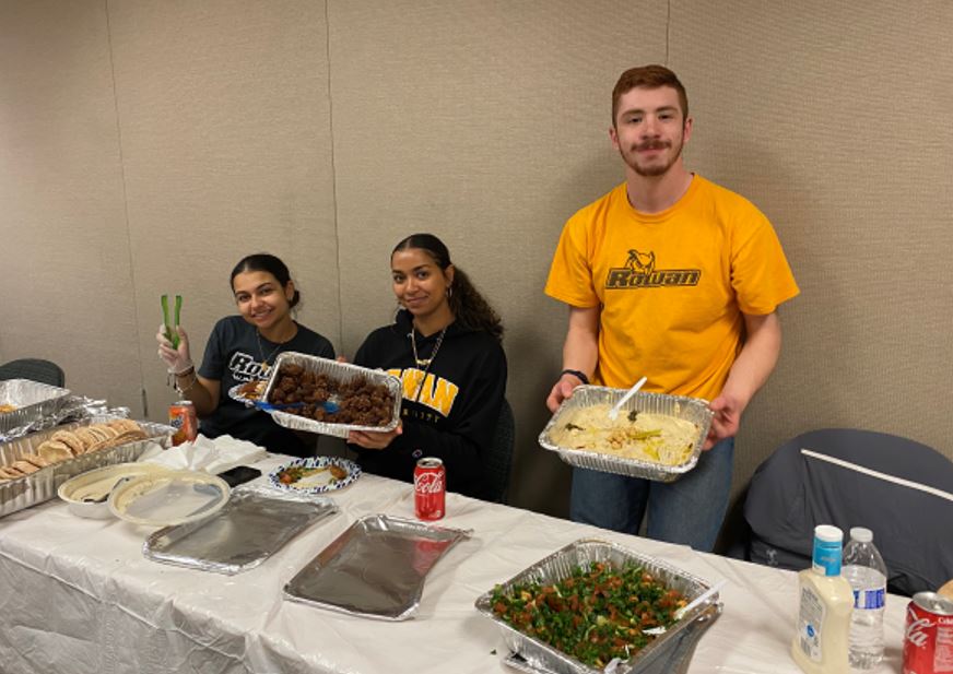 Students serving Arabic food.