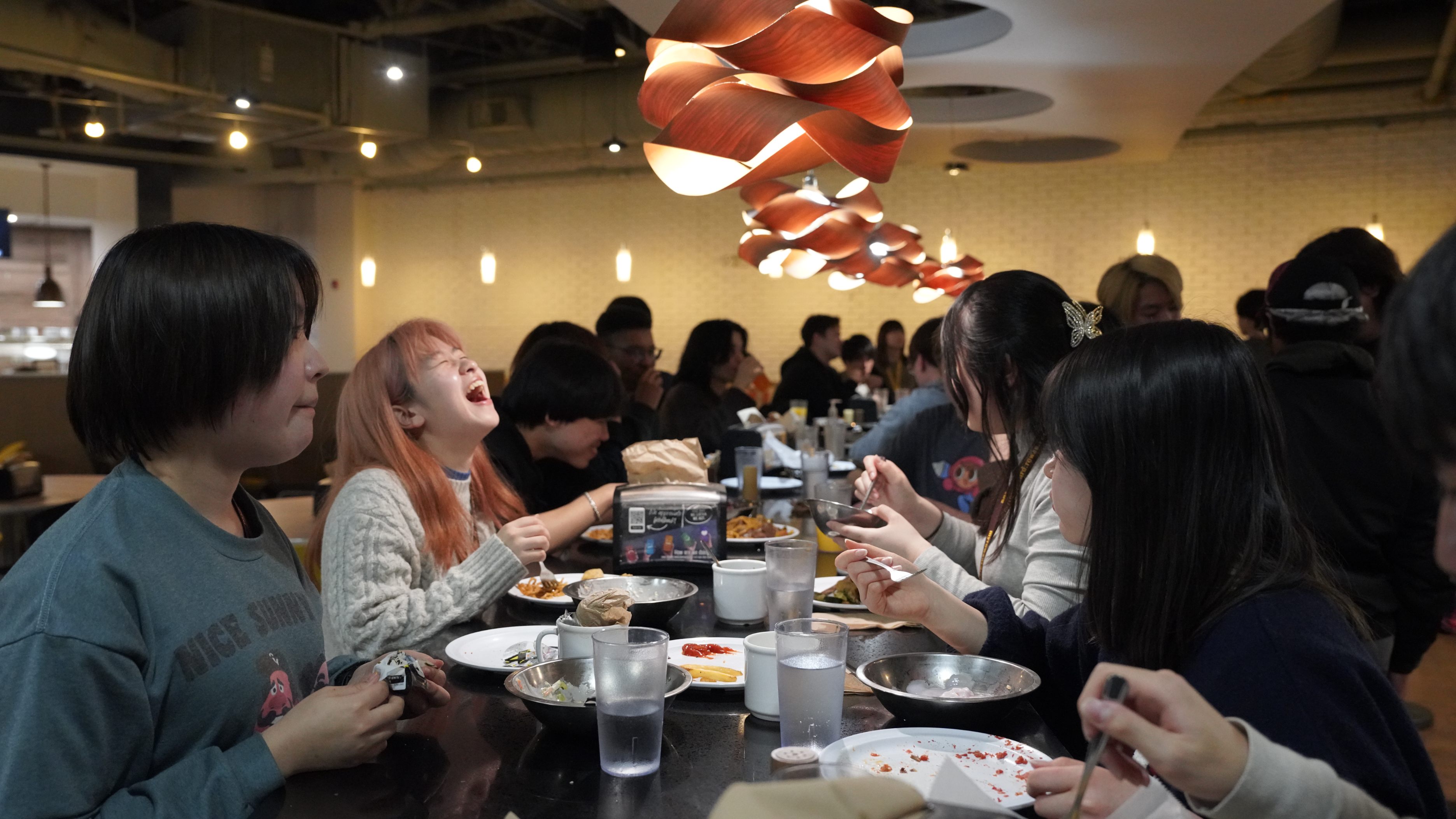JCC members and exchange students at a restaurant