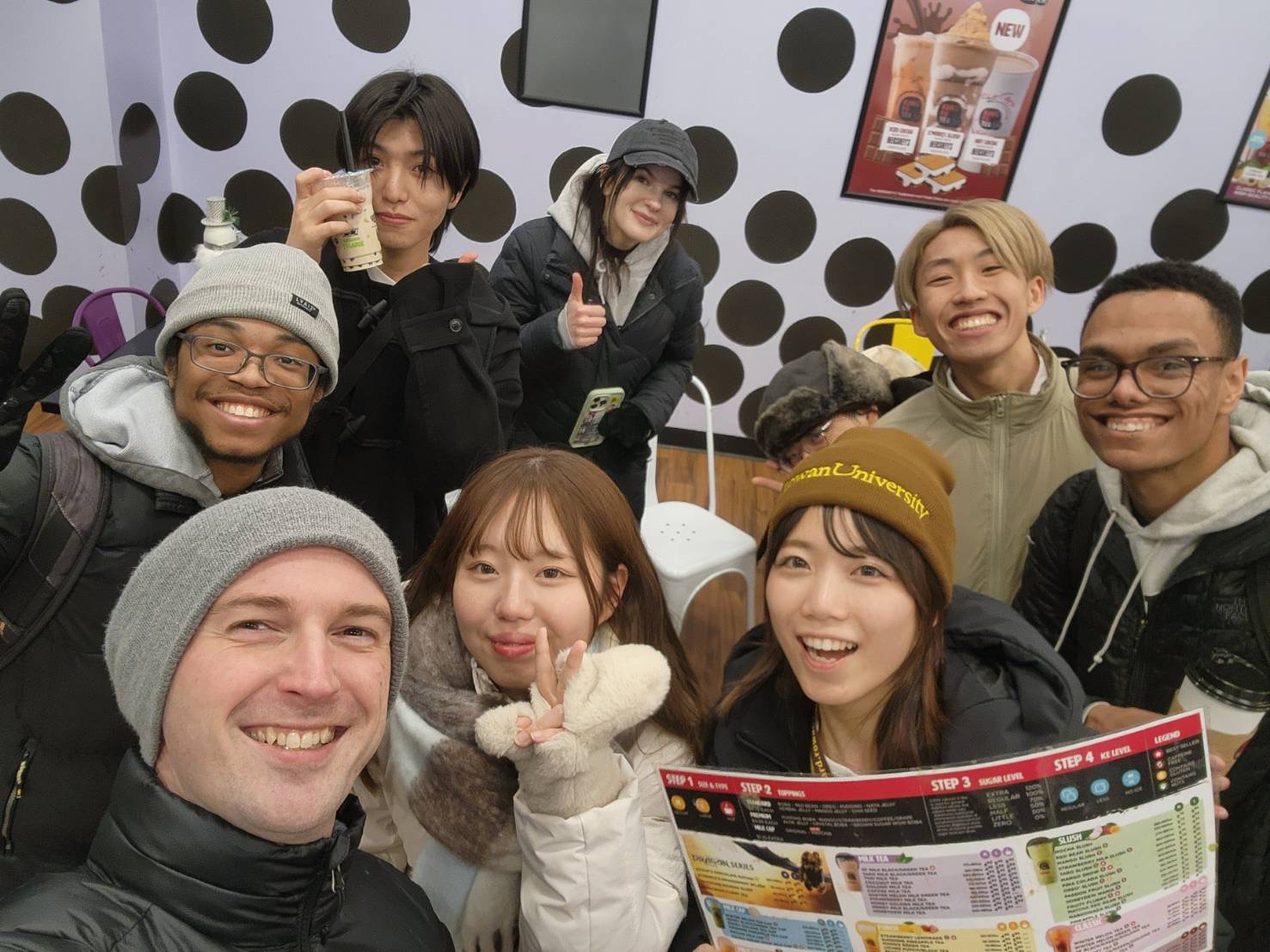 JCC members and exchange students smiling with boba drinks.
