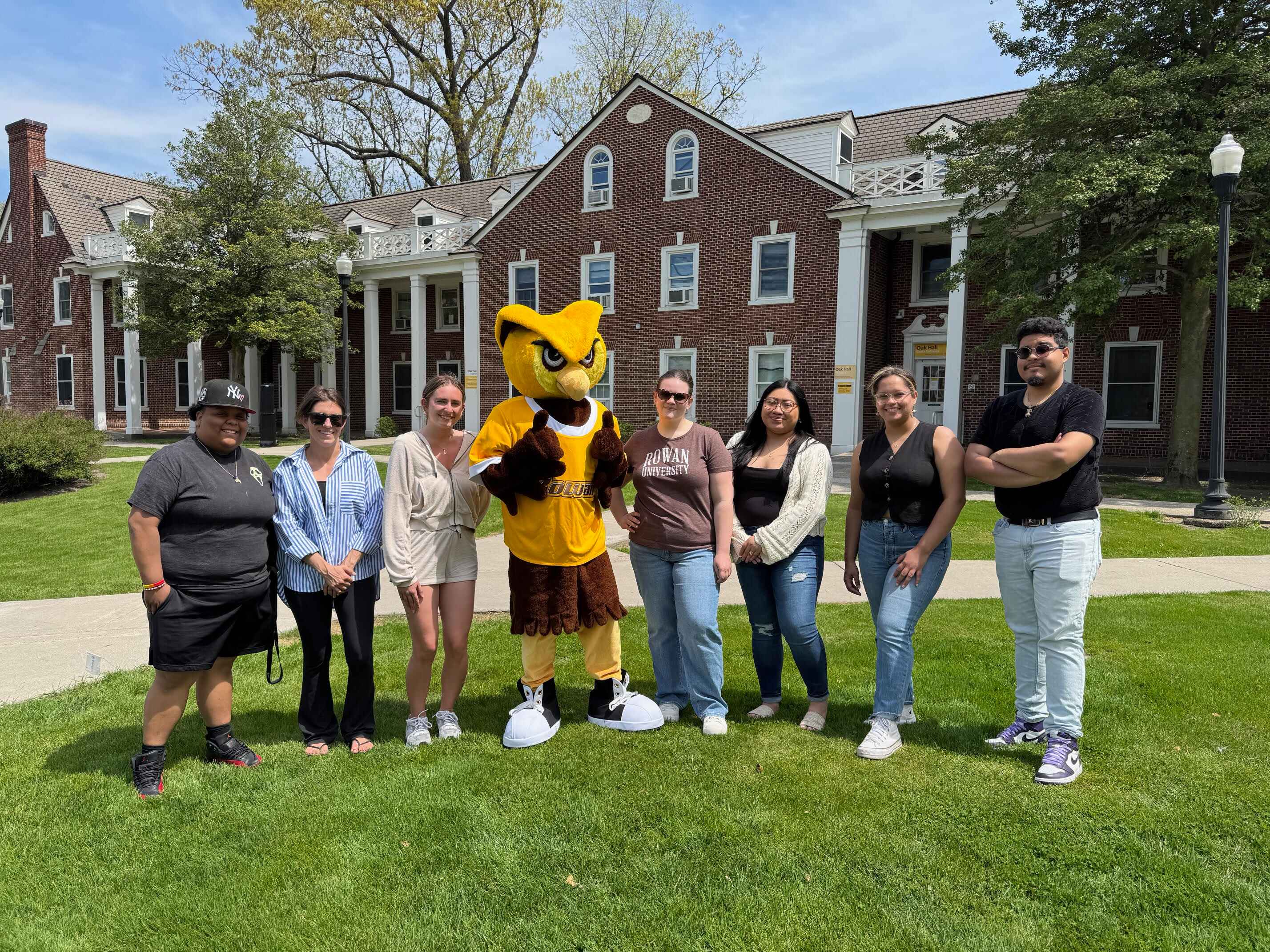 Spanish language students smiling with WhooRU in front of Oak Hall.