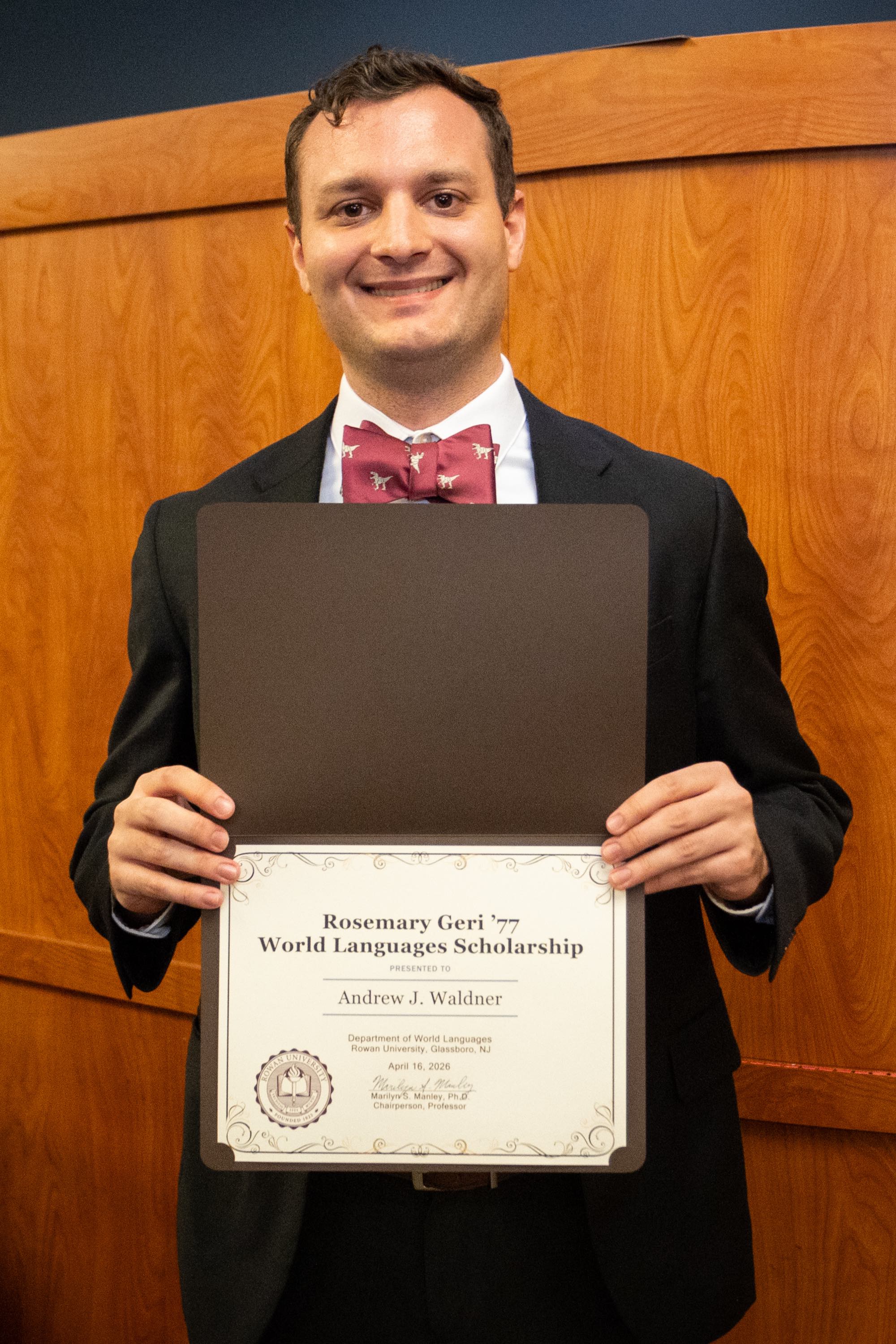 Student awardee smiling with certificate.