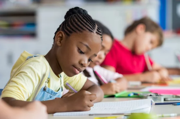 child writing at desk