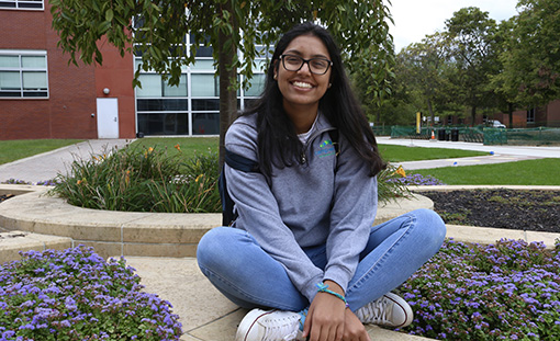 Ad club student sitting outside on campus