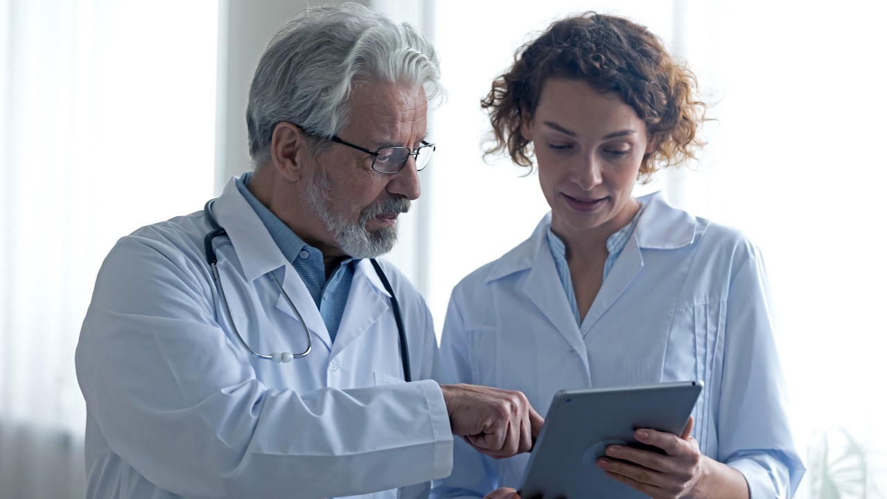 Doctor with nurse reading a chart